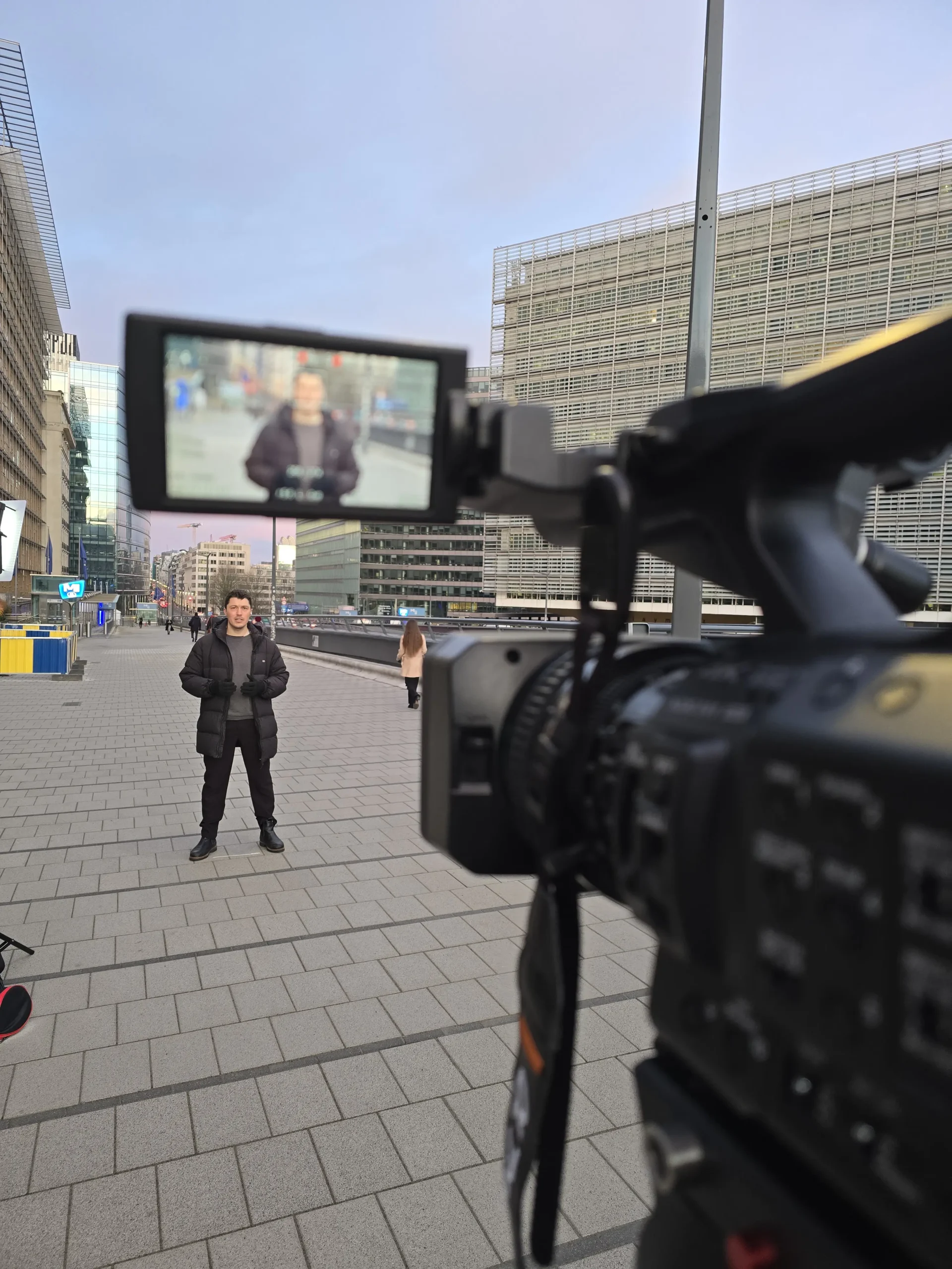 ProSieben reporter with LED light in front of European Commission Berlaymont building Brussels