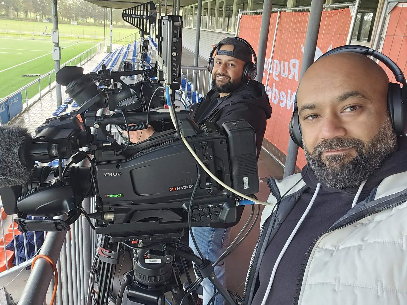 Two CamJo24 camera operators with their Sony broadcast cameras in the stand before the Rugby Europe Super Cup match
